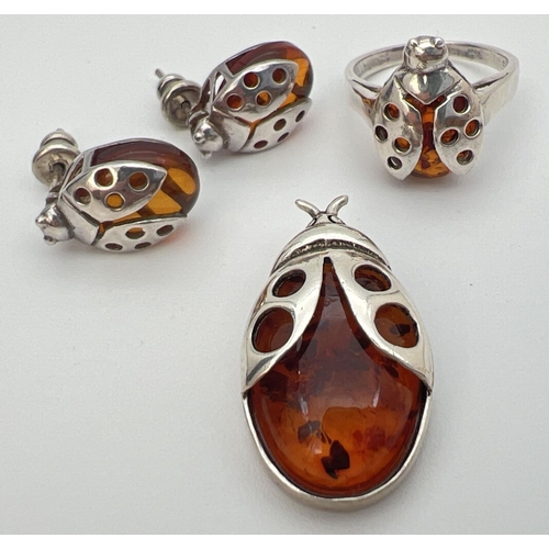 27 - A silver and cognac amber pendant, ring and matching earrings in the form of ladybirds. Ring and pen... 