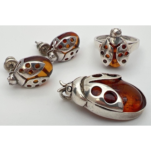 27 - A silver and cognac amber pendant, ring and matching earrings in the form of ladybirds. Ring and pen... 