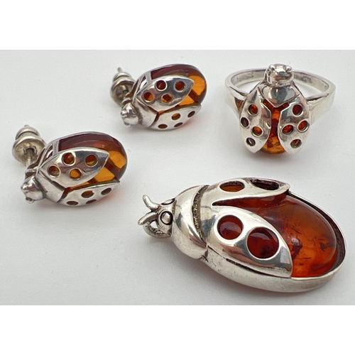 27 - A silver and cognac amber pendant, ring and matching earrings in the form of ladybirds. Ring and pen... 