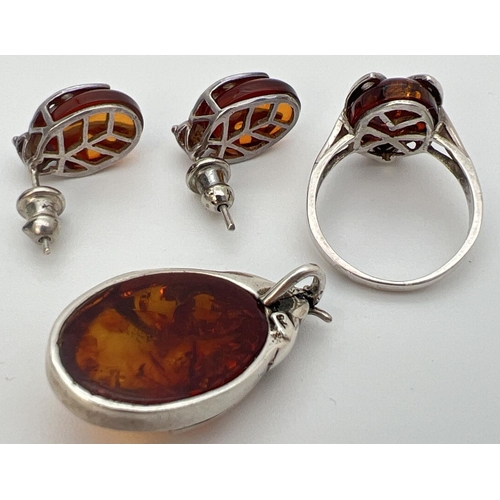 27 - A silver and cognac amber pendant, ring and matching earrings in the form of ladybirds. Ring and pen... 