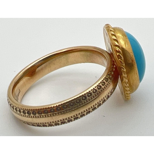 34 - A 9ct gold dress ring set with an oval cabochon of turquoise. Band of ring has studded engraved deta... 