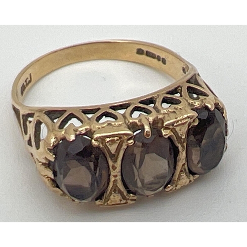 35 - A vintage 9ct gold an smoked quartz trilogy ring with a high mount setting of pierced heart design. ... 