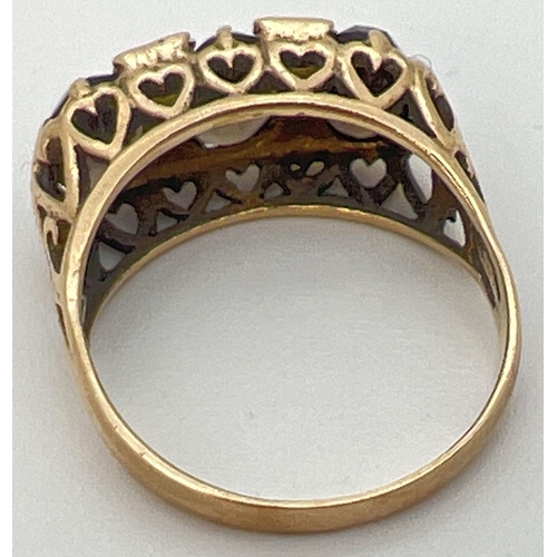 35 - A vintage 9ct gold an smoked quartz trilogy ring with a high mount setting of pierced heart design. ... 