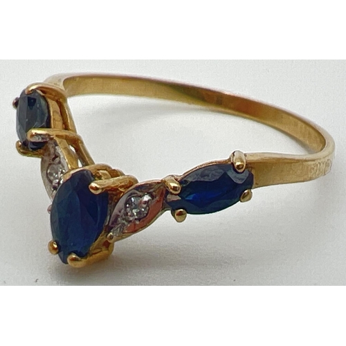 39 - A 9ct gold wishbone ring with 3 marquise cut sapphires and 2 illusion set diamonds. Fully hallmarked... 