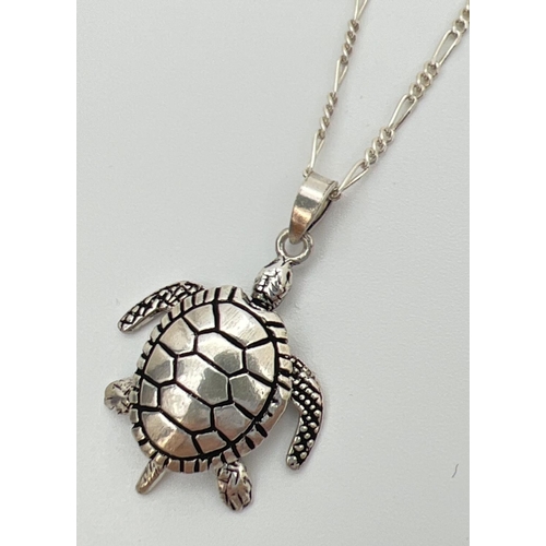 49 - A 925 silver articulated turtle pendant with moving arms, legs & tail. On an 18