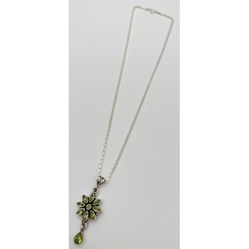 50 - A silver and peridot flower design pendant on an 18