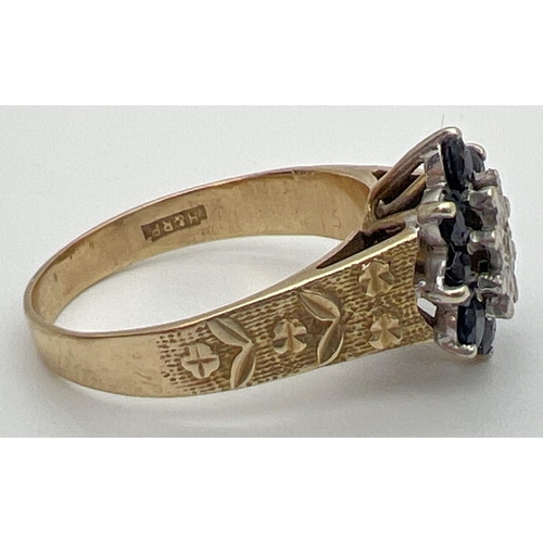 51 - A vintage 9ct gold, sapphire and diamond ring with textured shoulders with floral design. Central il... 