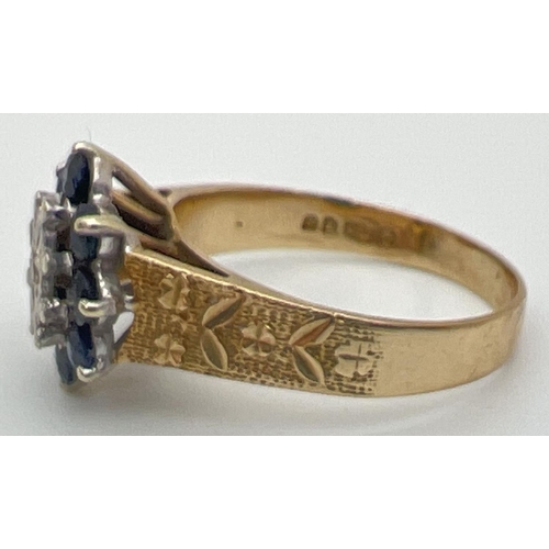 51 - A vintage 9ct gold, sapphire and diamond ring with textured shoulders with floral design. Central il... 