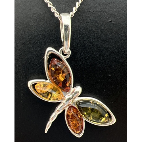 52 - A 925 silver and amber pendant in the form of a butterfly on an 18