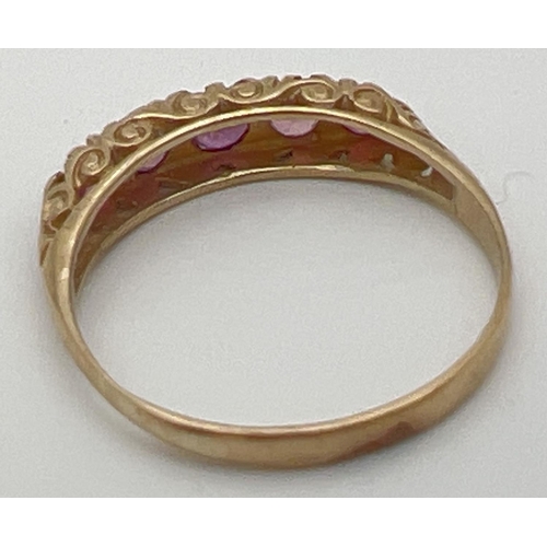 59 - A vintage 9ct and ruby eternity style ring with a scroll design mount. Fully hallmarked inside band.... 