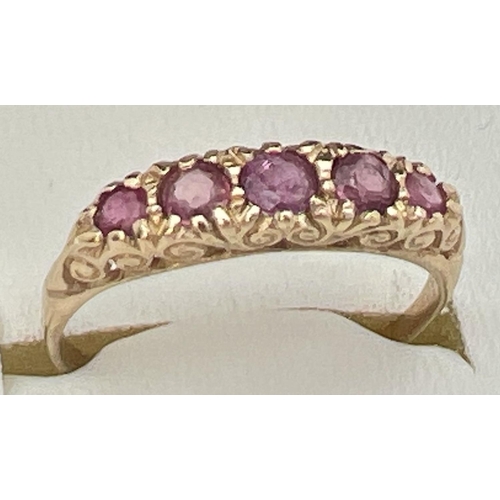 59 - A vintage 9ct and ruby eternity style ring with a scroll design mount. Fully hallmarked inside band.... 