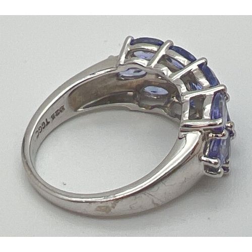 61 - A silver and tanzanite dress ring set with 13 oval cut tanzanite stones. From The Genuine Gem Compan... 