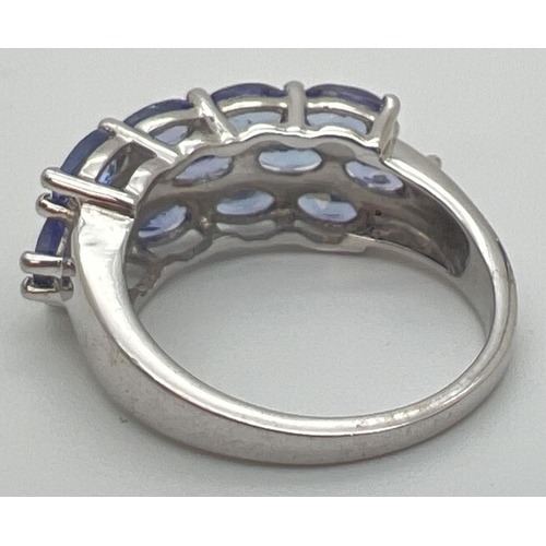 61 - A silver and tanzanite dress ring set with 13 oval cut tanzanite stones. From The Genuine Gem Compan... 