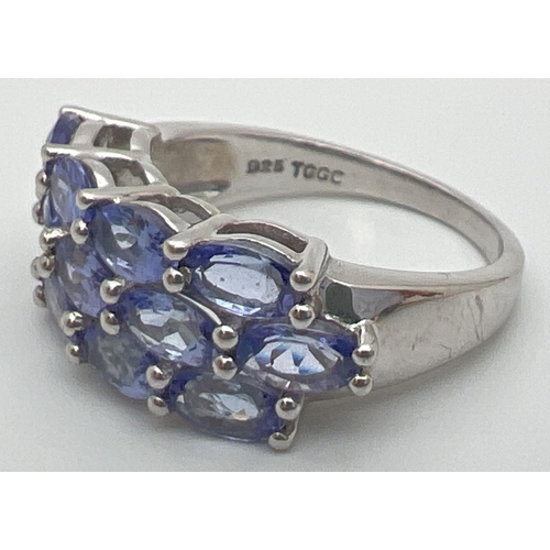 61 - A silver and tanzanite dress ring set with 13 oval cut tanzanite stones. From The Genuine Gem Compan... 