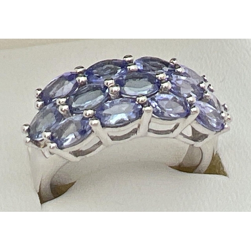 61 - A silver and tanzanite dress ring set with 13 oval cut tanzanite stones. From The Genuine Gem Compan... 