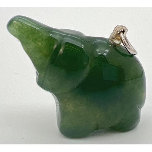 63 - A carved jade pendant in the form of an elephant, with white metal hanging bale. Approx. 2.5cm x 3cm... 