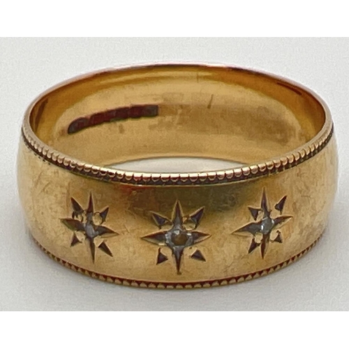 65 - A 9ct yellow gold gypsy style band ring set with 3 small diamonds in an engraved star shaped mount. ... 