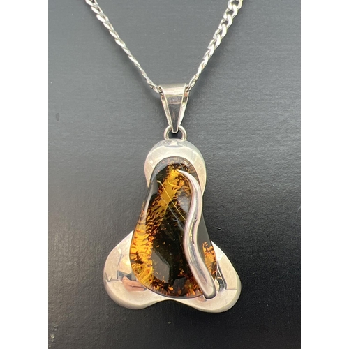 68 - A contemporary style 925 silver and amber pendant on an 18