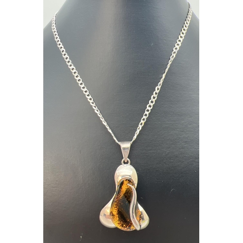 68 - A contemporary style 925 silver and amber pendant on an 18