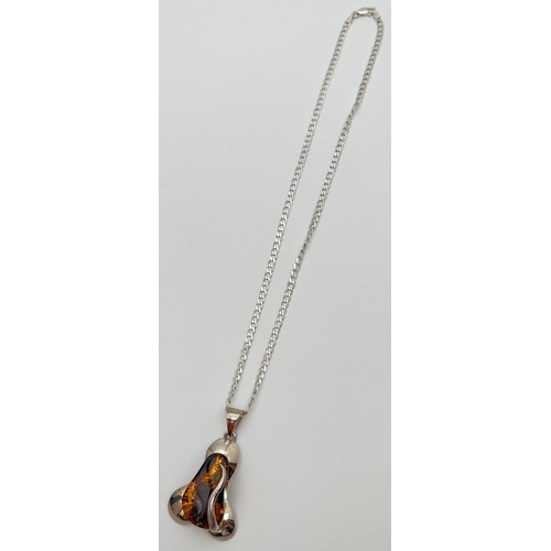 68 - A contemporary style 925 silver and amber pendant on an 18