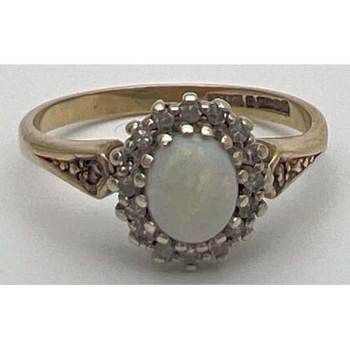 74 - A 9ct gold, opal and diamond dress ring set with central oval cabochon of opal. Surrounded by a halo... 