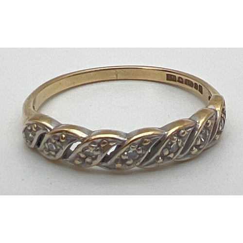 78 - A vintage 9ct gold and diamond eternity style ring with a twisted design setting. Open pierced work ... 