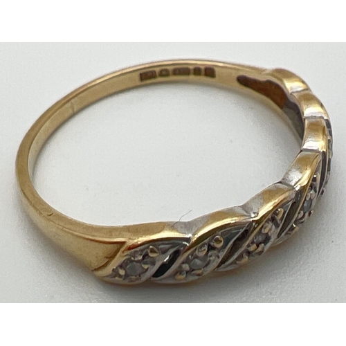 78 - A vintage 9ct gold and diamond eternity style ring with a twisted design setting. Open pierced work ... 