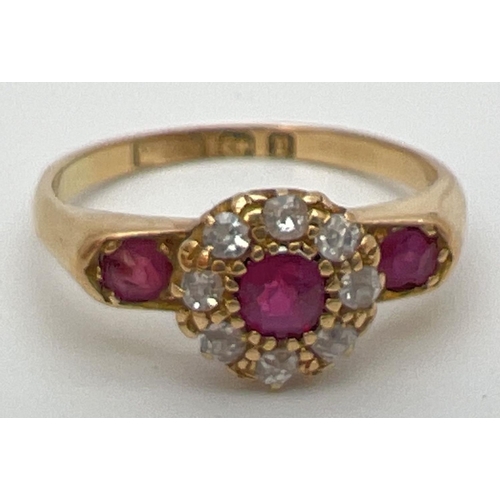 80 - A vintage 18ct gold, ruby and diamond ring with wide shoulder design setting. Central .2ct ruby surr... 