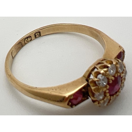 80 - A vintage 18ct gold, ruby and diamond ring with wide shoulder design setting. Central .2ct ruby surr... 