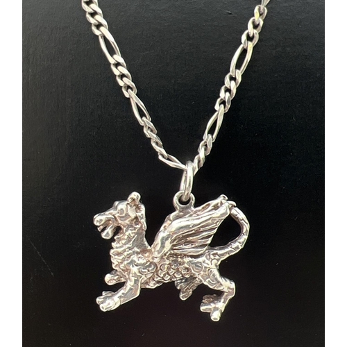 87 - A white metal pendant modelled as a dragon on a 19