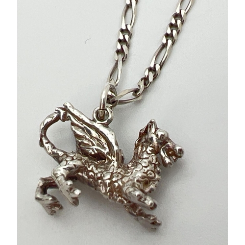 87 - A white metal pendant modelled as a dragon on a 19