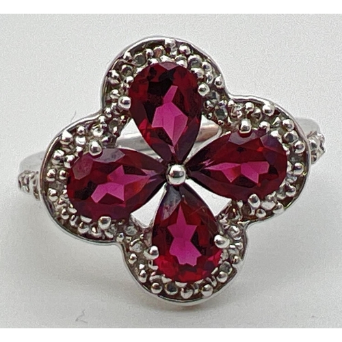 92 - A Genuine Gem Company pink tourmaline and clear stone set ring, in 925 silver. 4 pear cut pink tourm... 