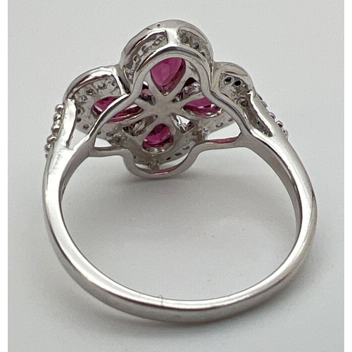 92 - A Genuine Gem Company pink tourmaline and clear stone set ring, in 925 silver. 4 pear cut pink tourm... 