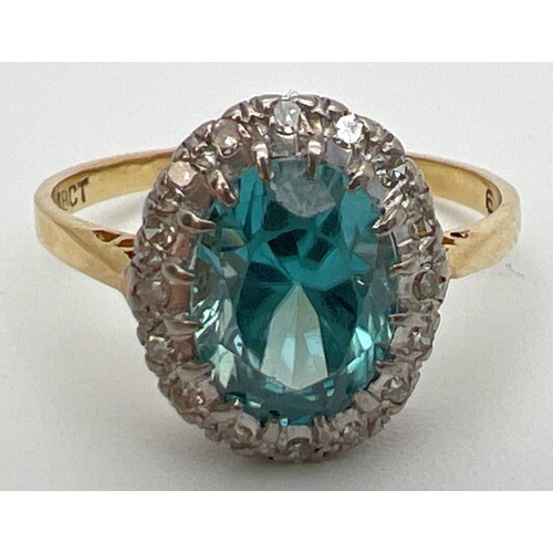 97 - An 18ct gold halo set London blue topaz and diamond dress ring. Large oval cut central topaz stone, ... 