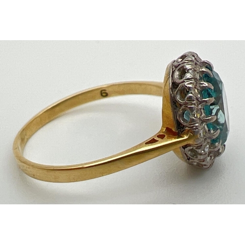 97 - An 18ct gold halo set London blue topaz and diamond dress ring. Large oval cut central topaz stone, ... 