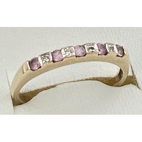 98 - A 9ct gold, pink topaz and diamond eternity ring set with alternating stones. Fully hallmarked insid... 