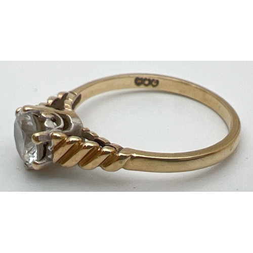 101 - A vintage 9ct gold clear stone solitaire ring with twisted design to shoulders. Fully hallmarked ins... 