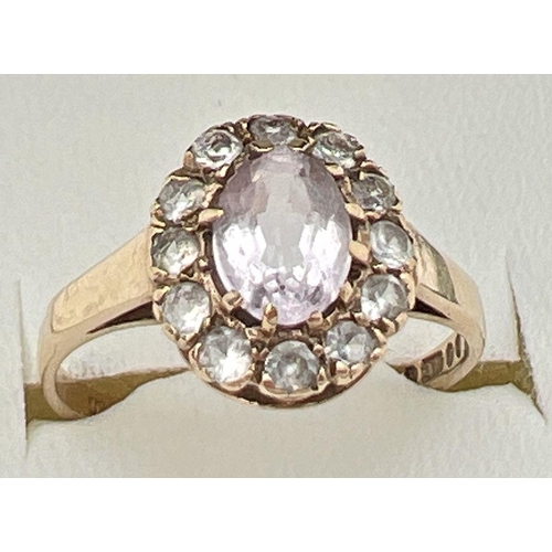 102 - A vintage 9ct gold halo set ring with central oval cut Rose de France stone. Surrounded by 12 cubic ... 