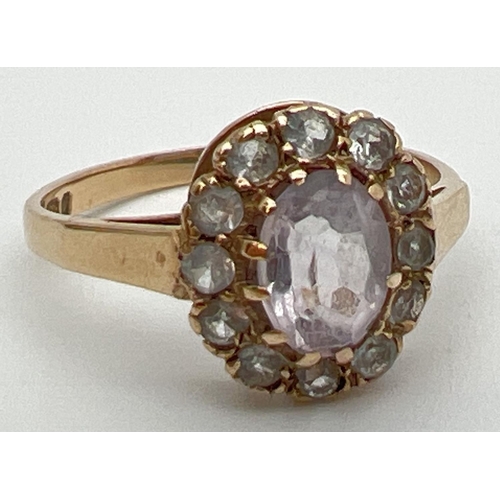 102 - A vintage 9ct gold halo set ring with central oval cut Rose de France stone. Surrounded by 12 cubic ... 