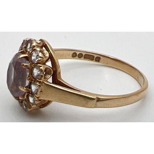 102 - A vintage 9ct gold halo set ring with central oval cut Rose de France stone. Surrounded by 12 cubic ... 