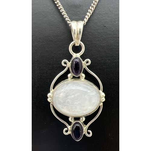 103 - A moonstone & amethyst set silver pendant on a 925 silver 18