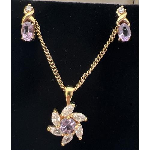 107 - A gold plated pendant necklace and earrings set with amethyst and cubic zirconias. Flower shaped pen... 