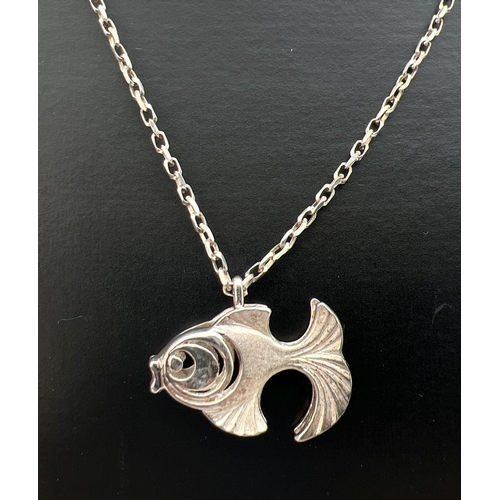 108 - A white metal pendant modelled as a fish, on a 17