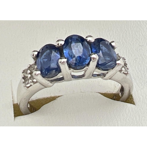 109 - A sterling silver Genuine Gem Company trilogy style ring set with Himalayan Kyanite and white topaz.... 