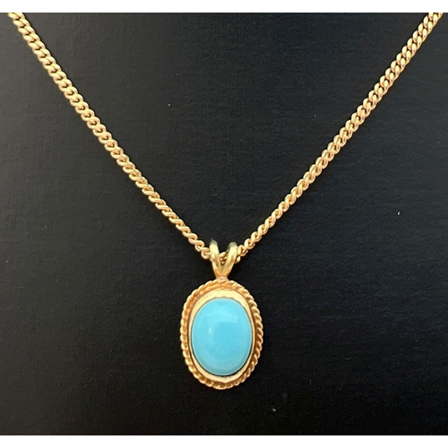 114 - A turquoise and 9ct gold oval shaped pendant on an 18