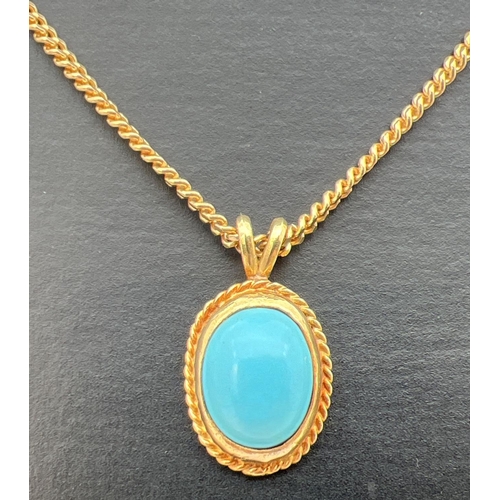 114 - A turquoise and 9ct gold oval shaped pendant on an 18