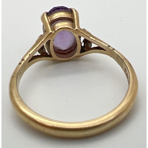 115 - A 9ct gold and amethyst dress ring with large oval cut stone and decorative shoulders. Stone approx.... 