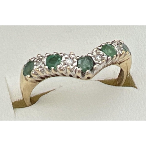 116 - A 9ct gold emerald and diamond wishbone ring set with alternating emeralds and illusion set diamonds... 