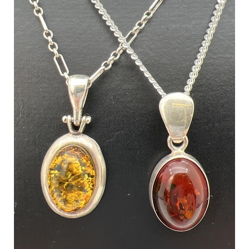 117 - 2 silver and amber oval shaped pendants on 18