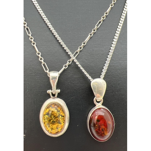 117 - 2 silver and amber oval shaped pendants on 18